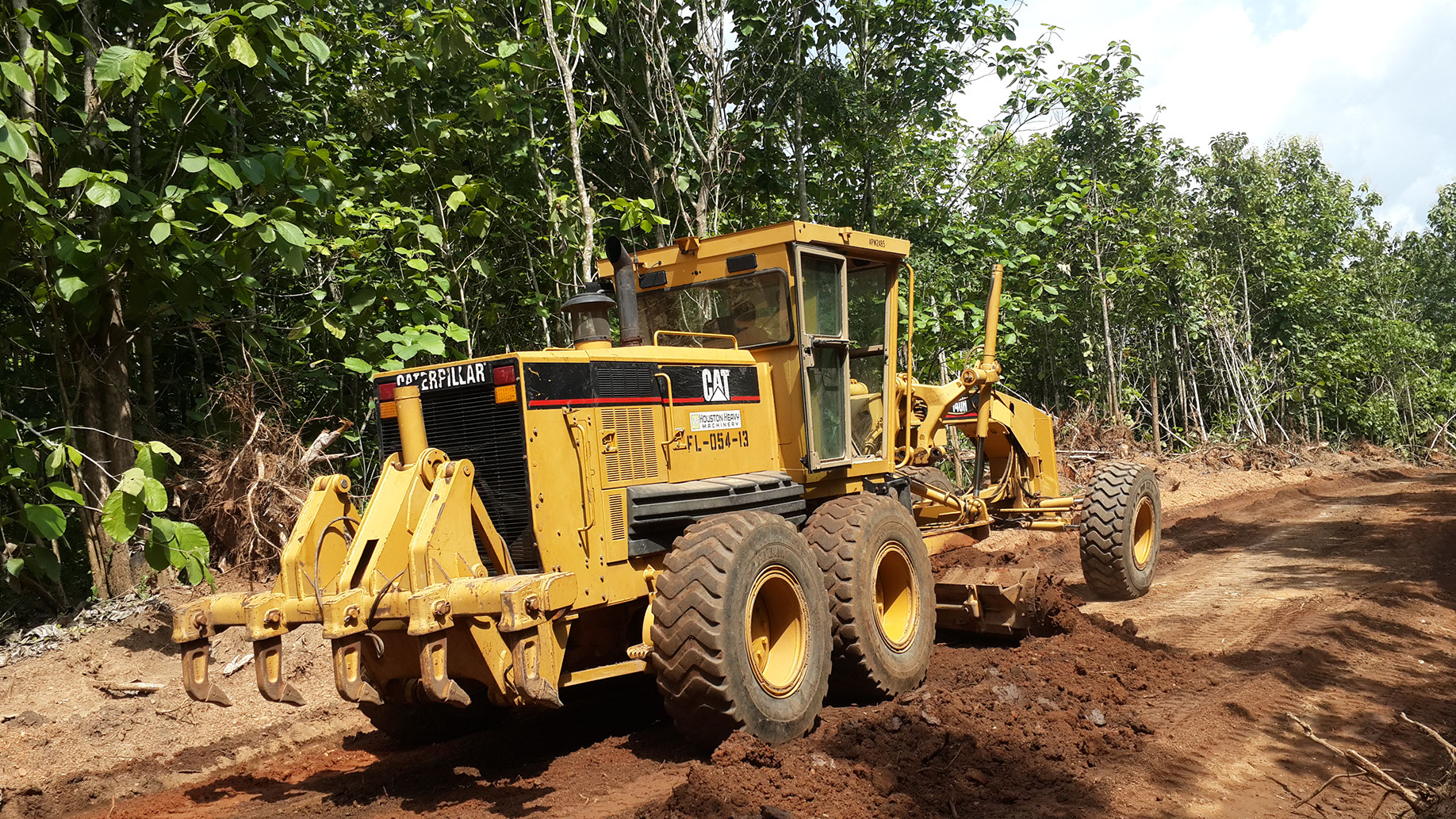 One of our graders grading farm road